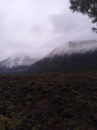 a view of a mountain with snow covered mountains at Cabaña Kiñeco in Melipeuco