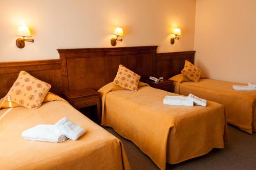 Una cama o camas en una habitación de Konke Calafate Hotel