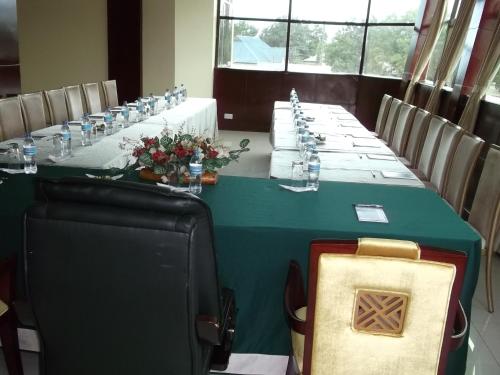 a long table in a room with a green table at Greenlight Hotel in Dar es Salaam