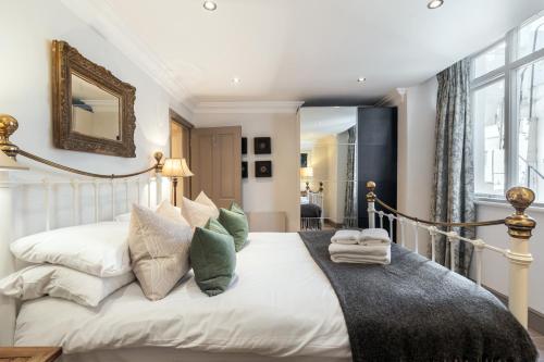 1 dormitorio con 1 cama blanca grande con almohadas en The Brunswick Oasis en Londres