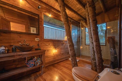 a bathroom with a sink and a toilet in a cabin at La Gloria Reserva Forestal in La Calera