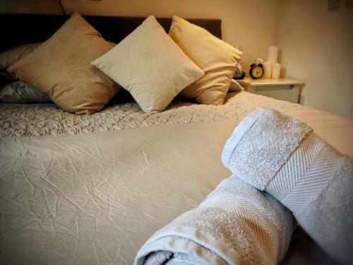 a close up of a bed with towels on it at Hursley Rooms - The Dolphin in Winchester