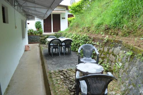 a group of tables and chairs on a patio at Rheinberg Town Haus in Munnar