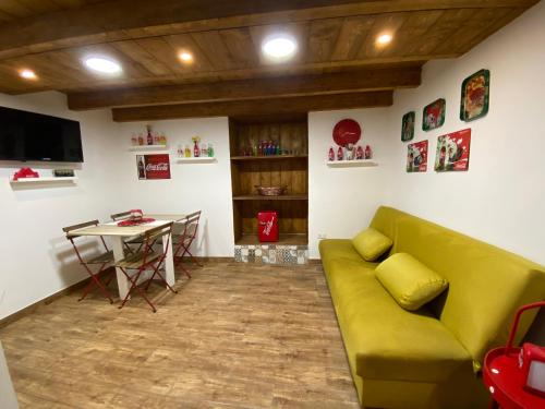 un salon avec un canapé vert et une table dans l'établissement Vat' Coke House, à Naples