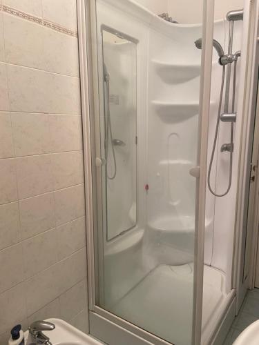 a shower with a glass door next to a sink at GlampingCashmereHause in Rivotorto 