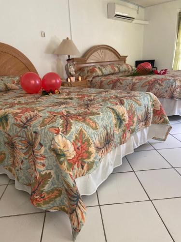 a hotel room with two beds with red balloons at The Downtown Hotel in Soufrière