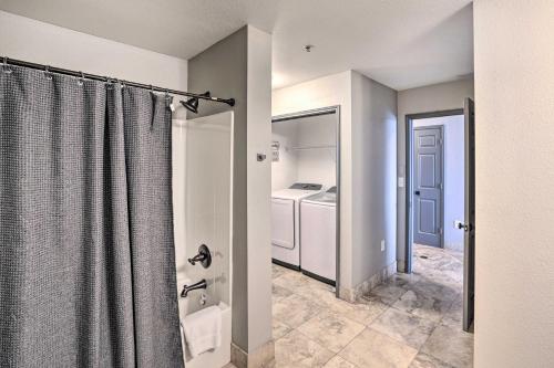 a bathroom with a shower with a shower curtain at Shop and Dine Fort Worth Condo with Racetrack Views! in Fort Worth