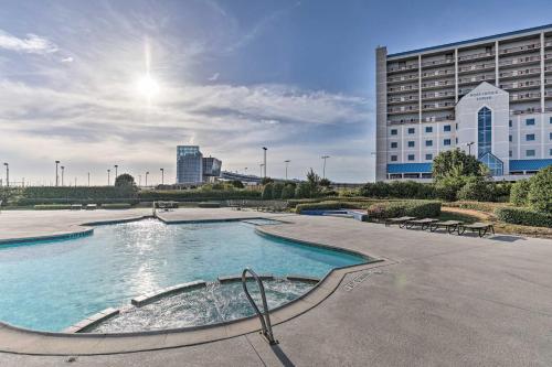a large swimming pool in a city with a building at Shop and Dine Fort Worth Condo with Racetrack Views! in Fort Worth