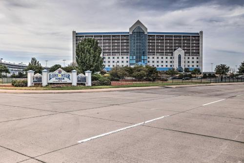 a parking lot in front of a large building at Shop and Dine Fort Worth Condo with Racetrack Views! in Fort Worth
