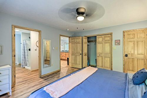 a bedroom with a blue bed and wooden floors at Family Home in Albrightsville with Furnished Deck in Albrightsville