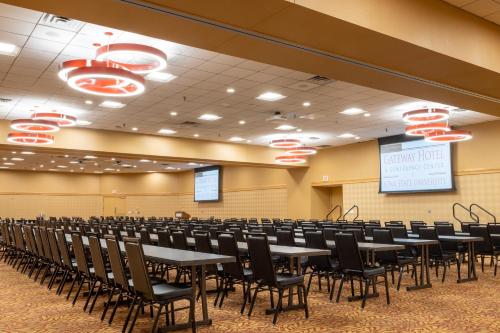 a conference room with tables and chairs in it at Gateway Hotel and Conference Center in Ames