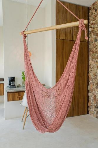 a hammock hanging in a living room at Saak Luúm Ruta Puuc in Sacalum