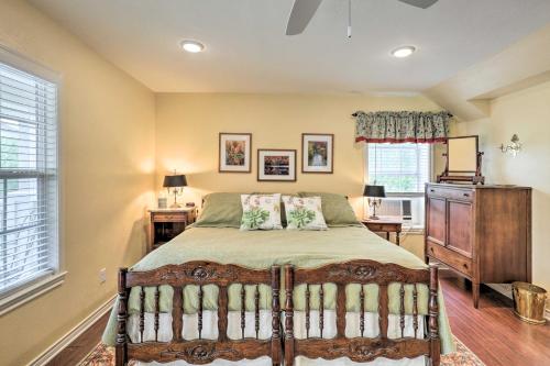 a bedroom with a bed and a dresser and windows at Studio in College Station with Expansive Deck! in College Station