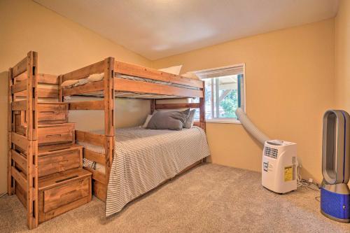 a bedroom with a wooden bunk bed and a window at Lovely Detroit Home with Deck - Walk to Town! in Detroit
