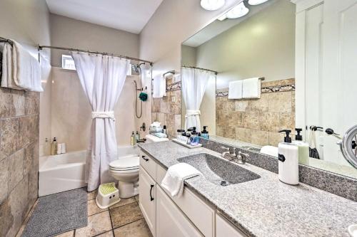 a bathroom with a sink and a toilet and a tub at Classy Bellemont Home with Hot Tub and Playground in Bellemont