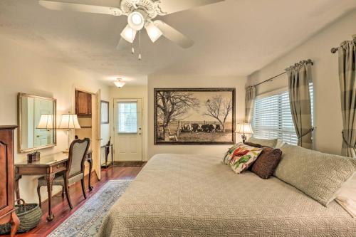 a bedroom with a bed with a ceiling fan and a desk at College Station Studio Less Than 1 Mi to Kyle Field! in College Station
