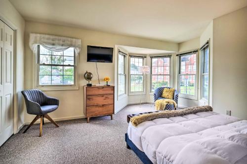 a bedroom with a bed and a dresser and windows at Historic Dtwn Home 2 Mi to Military Park! in Gettysburg