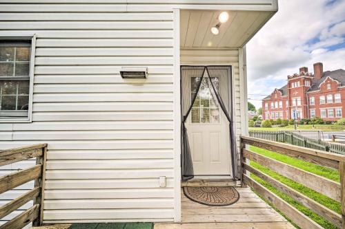 a white door on a house with a wooden porch at Historic Dtwn Home 2 Mi to Military Park! in Gettysburg