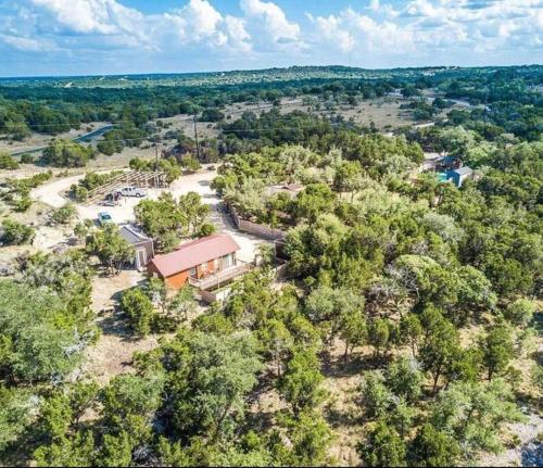 an aerial view of a house in the woods at The Armadillo Cabin - Cabins At Rim Rock in Austin