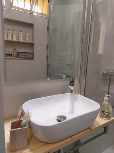 uma casa de banho com um lavatório branco e um chuveiro em 2 Via Fabio Mangone em Milão