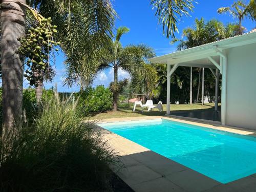 a swimming pool in the backyard of a house at EAST KEYS - East Villa Muscade in Le Vauclin