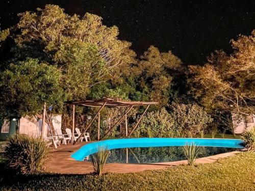 a blue slide in front of a pond at night at EL PASO IBERA in Colonia Carlos Pellegrini
