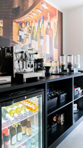 a refrigerator filled with lots of bottles of wine at B&B Koor91 in Hasselt