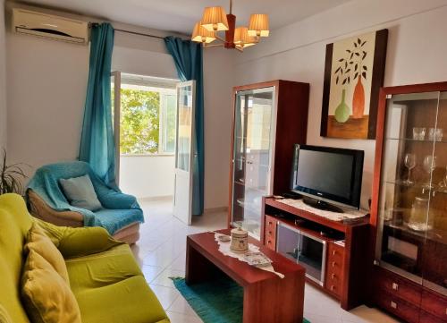a living room with a couch and a tv at Tavira City Center 3Br in Tavira