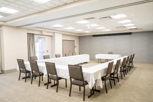 a conference room with white tables and chairs at Country Inn & Suites by Radisson, State College Penn State Area , PA in State College