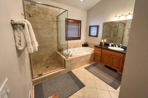 a bathroom with a tub and a shower and a sink at Outlaw Hideaway in Telluride