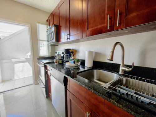 a kitchen with a sink and a counter top at Marlins Park Suites - Apartment 1 - Calle Ocho Suite in Miami