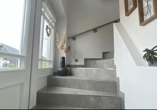 a staircase in a house with a vase on it at Studio - Apartment Steinmetz mit Balkon in Reken