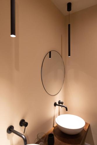 a bathroom with a sink and a mirror on the wall at labotanica_casalounge in Cesenatico