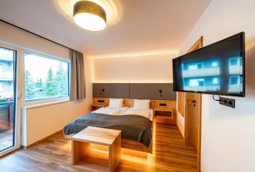 Postel nebo postele na pokoji v ubytování Rustika - Appartements & Spa