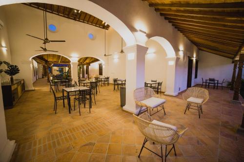 a room with tables and chairs in a building at Karakali Boutique Hotel in Mompos