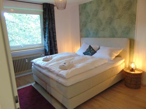 - une chambre avec un lit blanc et une fenêtre dans l'établissement Harz Reloaded Thomsen, à Hahnenklee