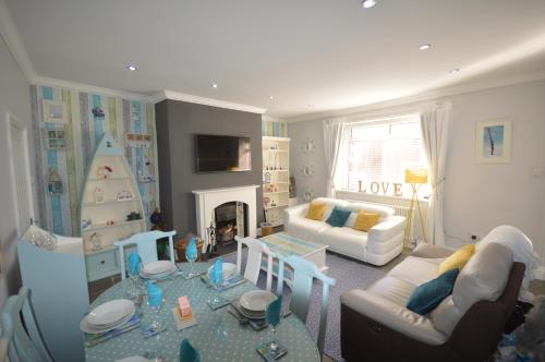 a living room with a couch and a table at Sandridge in Newbiggin-by-the-Sea