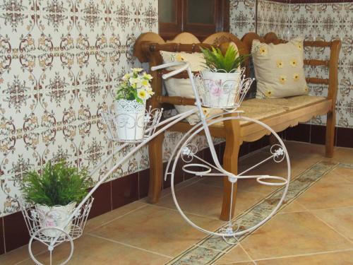 a bench with potted plants on it in a room at Casa Rural La Calderina in Urda