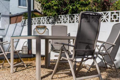 a table and chairs sitting next to a table and chairs at Parke -HotTub- Apartment in Pembroke Dock