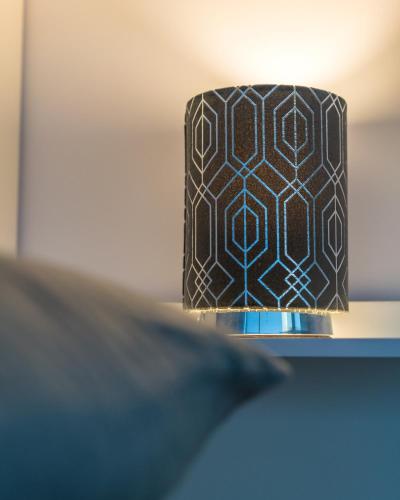 a black and white lamp shade on a table at Parke -HotTub- Apartment in Pembroke Dock