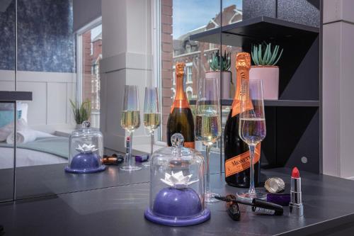 a table with wine bottles and glasses on it at Ocean View Apartments - Mayfair in Blackpool