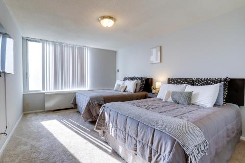 a bedroom with two beds and a large window at Great 1 Bedroom Condo At Arlington With Gym in Arlington