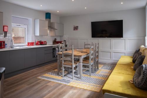 a kitchen and dining room with a table and chairs at Ocean View Apartments - Chelsea in Blackpool