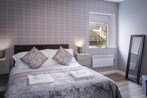 a bedroom with a large bed with two towels on it at Ocean View Apartments - Chelsea in Blackpool