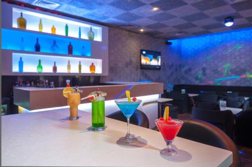 a table with four different colored drinks on it at Nanutel Margao in Madgaon
