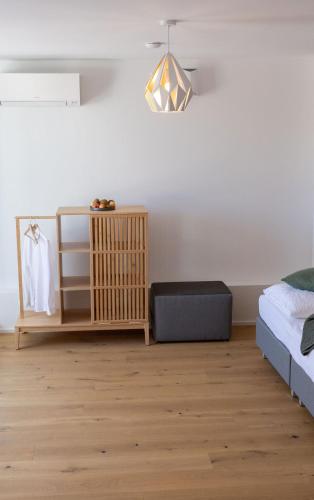 a living room with a bed and a table at geislerAPPARTMENTS in Gramatneusiedl