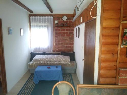 Kleines Zimmer mit einem Bett und einem Tisch in der Unterkunft Ribarska Vila in Donje Lohovo