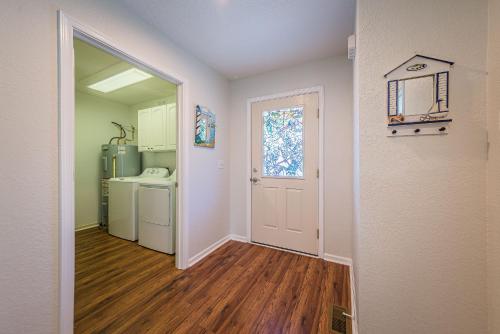 an empty room with a kitchen and a hallway with a door at Ocean View's in Kill Devil Hills