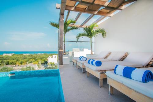 a villa with a view of the pool and the ocean at Condos with ocean view pool in Av 10 & 60 street in Playa del Carmen
