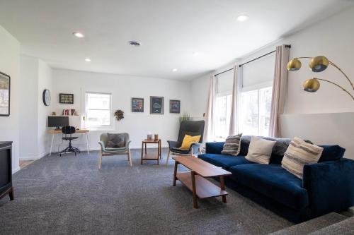 a living room with a blue couch and chairs at Pocono Lake Retreat - Relaxing 3bdm retreat w/ High Speed Wi-Fi, Work Space and Firepit in Pocono Lake